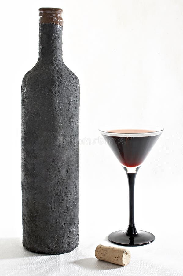 Old Bottle of Wine with a Full Beaker of Wine and Cork Stock Photo