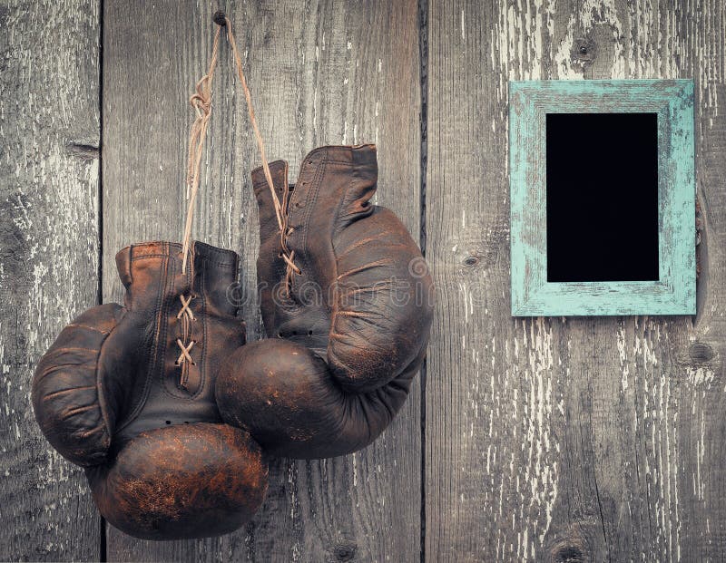 Old boxing gloves and frame for photo stock photos Old boxing gloves and frame for photo stock photos