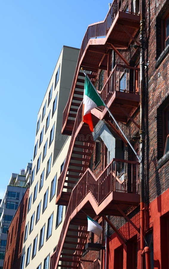 Old Brick Building with Irish Flag on Fire Escape Stock Photo Image