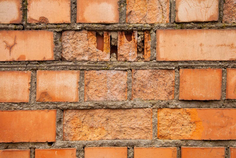 Old Brick Wall Made of Red Bricks. Breaking Down a Wall Falling Apart