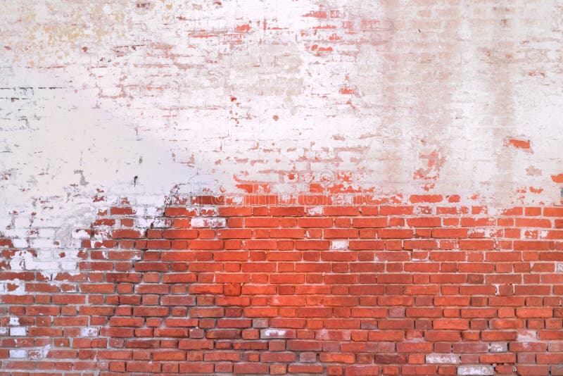 Brick wall visible through the worn white paint. Brick wall visible through the worn white paint