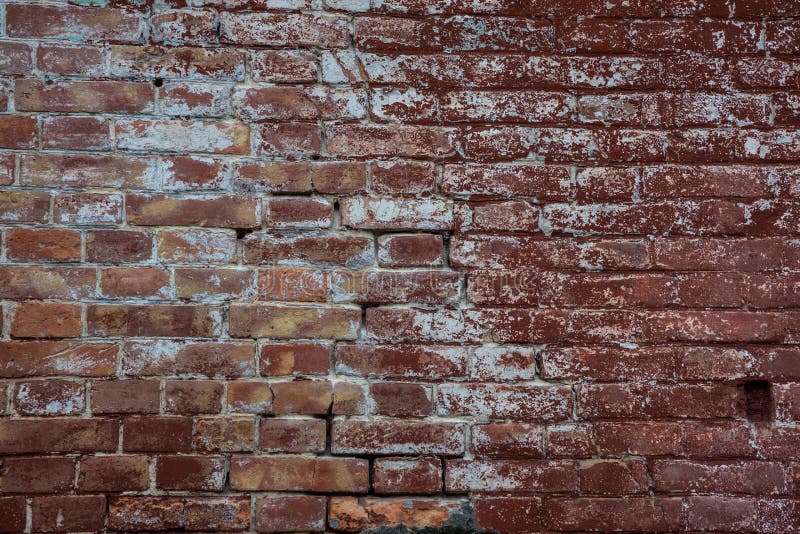 Old Brick Wall of Red Color with Scratches and White Spots. Stock Photo