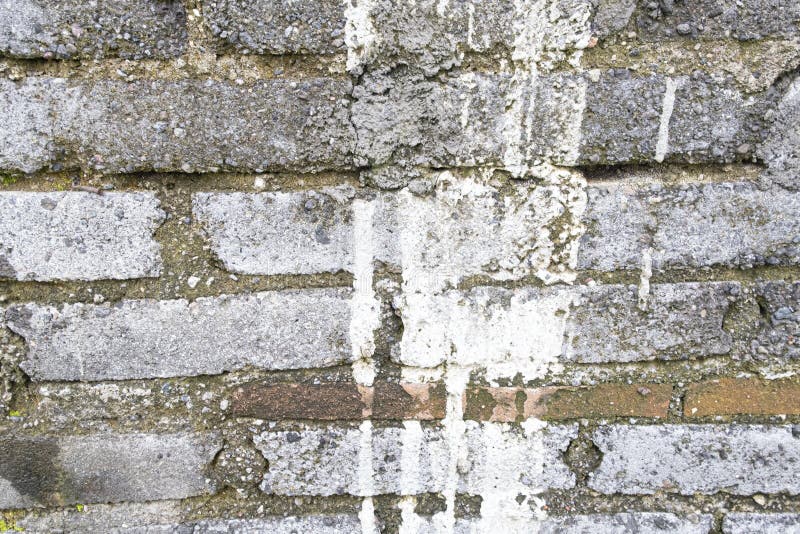 Old Brick Wall with Mortar and White Paint Dripping Down. Background