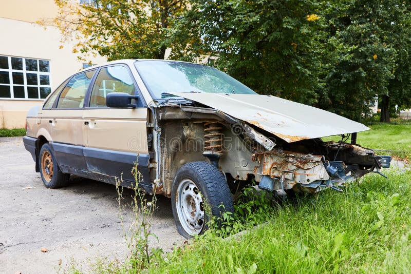 Old Broken Rusty Car without Bumper Engine and Fenders Stock Photo