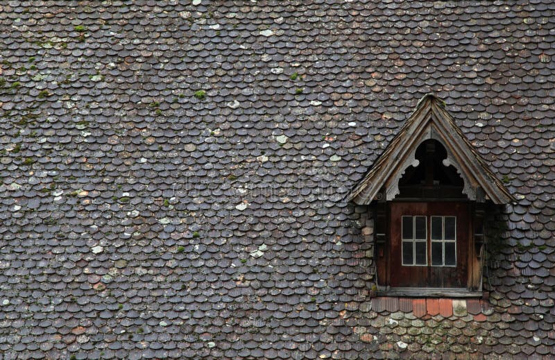 Old brown tile roof with dormer stock photography
