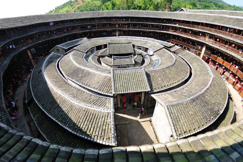 Earthen Houses (Tulou), Fujian Province Earthen houses represent a vernacular architecture specific to Jiangxi, Fujian and Guangdong provinces following the flow of the Hakka people from central China to the South. As most Hakka resided in mountains, communal houses made of compacted earth were built to provide protection against bandits and wild animals. The older examples of this style of construction consist of interior buildings enclosed by huge peripheral ones holding hundreds of rooms and dwellers. With all the halls, storehouses, wells and bedrooms inside, the huge towerlike building functions almost as a small fortified city. Earthen houses are made of earth, stone, bamboo and wood, all readily available materials. After constructing the walls with rammed earth, branches, strips of wood and bamboo chips were laid in the wall as bones to reinforce it. The end result is a well lit, well-ventilated, windproof, quakeproof building that is warm in winter and cool in summer. Earthen Houses (Tulou), Fujian Province Earthen houses represent a vernacular architecture specific to Jiangxi, Fujian and Guangdong provinces following the flow of the Hakka people from central China to the South. As most Hakka resided in mountains, communal houses made of compacted earth were built to provide protection against bandits and wild animals. The older examples of this style of construction consist of interior buildings enclosed by huge peripheral ones holding hundreds of rooms and dwellers. With all the halls, storehouses, wells and bedrooms inside, the huge towerlike building functions almost as a small fortified city. Earthen houses are made of earth, stone, bamboo and wood, all readily available materials. After constructing the walls with rammed earth, branches, strips of wood and bamboo chips were laid in the wall as bones to reinforce it. The end result is a well lit, well-ventilated, windproof, quakeproof building that is warm in winter and cool in summer.