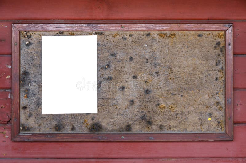 Old bulletin board with an empty white note on red wall royalty free stock image