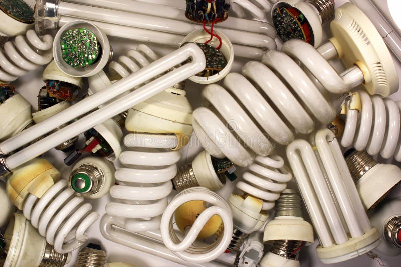 Old burnt fluorescent energy saving lamps. Hazardous and toxic e