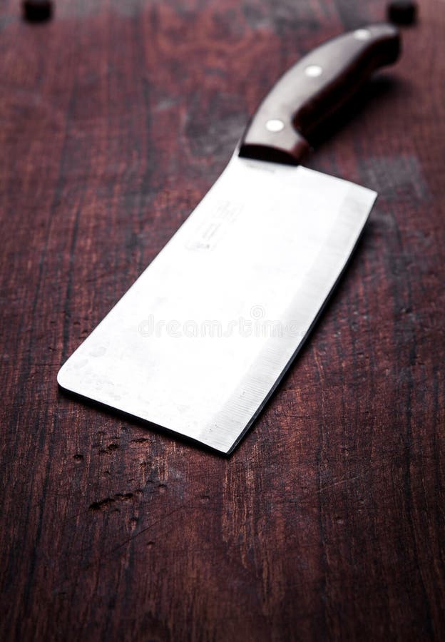 Old butcher knife, on wooden background. Kitchen, cooking.