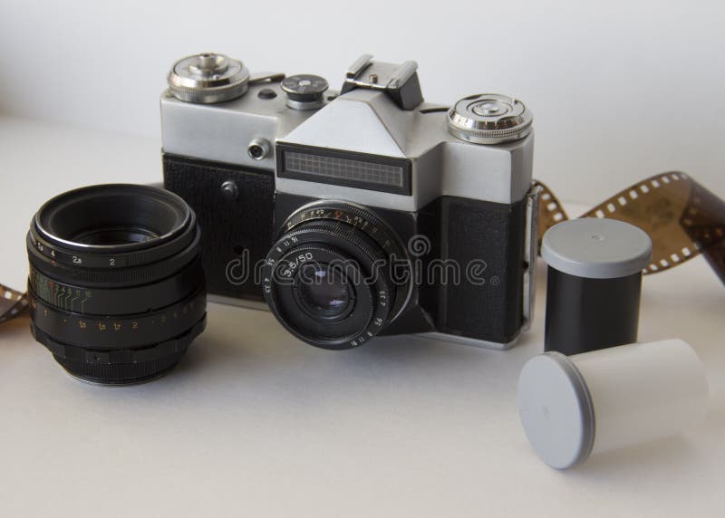 Old camera and film on white background stock photos Old camera and film on white background stock photos