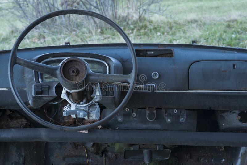 Old car abandoned, dashboard and steering wheel