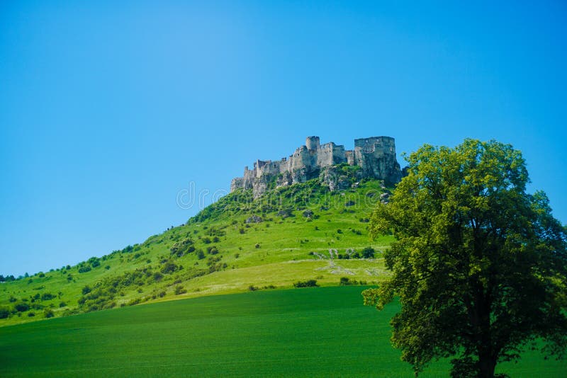 Old castle in Tatra mountains with blue sky background.