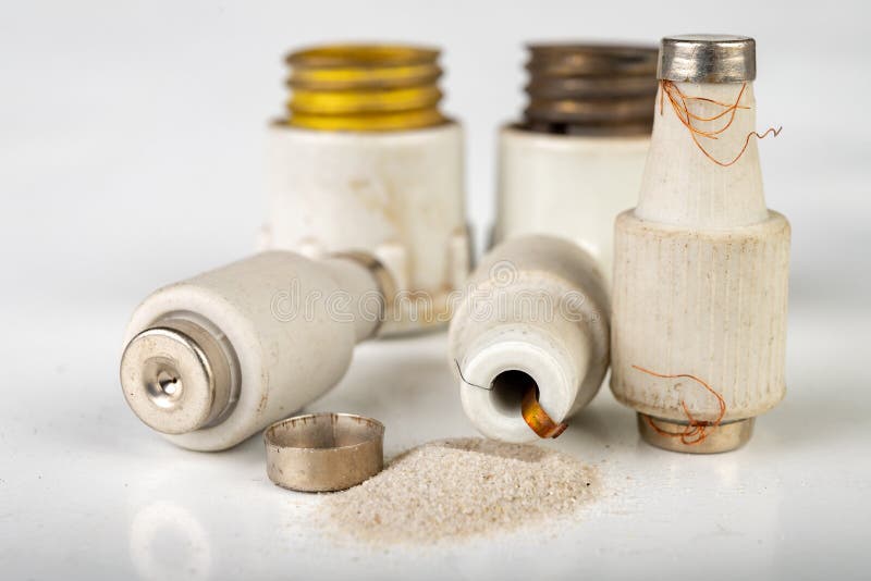 Old ceramic electric fuse. Blown and badly repaired security for energy stock image
