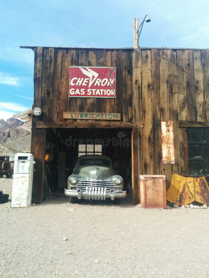 Old Chevron gas station with car in garage, in the desert. Old Chevron gas station with car in garage, in the desert.