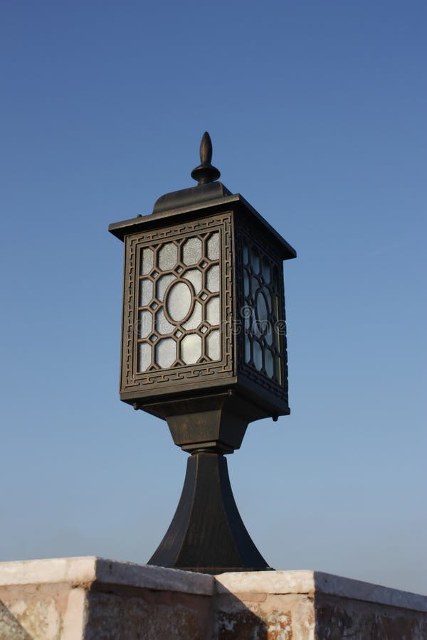 Old city lamp isolated on blue sky