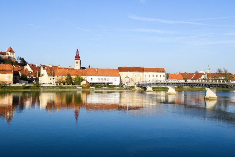 Old city Ptuj with castle and a reflection in river Drava.