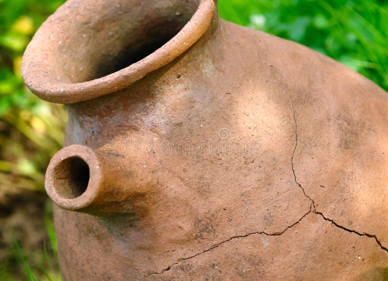 Old clay pot on grass stock image. Image of empty, cracks 115179401