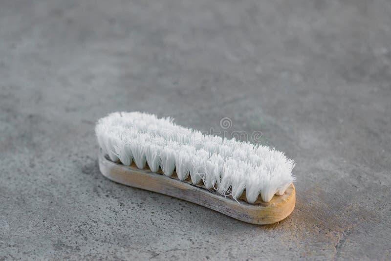 Old Cleaning Brush or Washing Brush on Concrete Floor Stock Photo