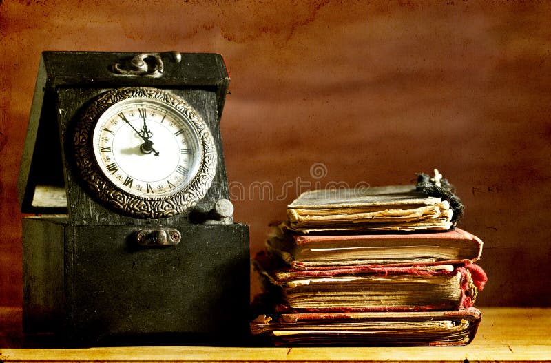 Old clock and vintage books on grunge background