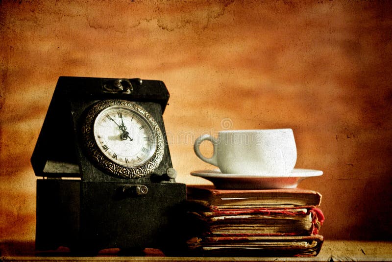 Old clock and vintage books on grunge background