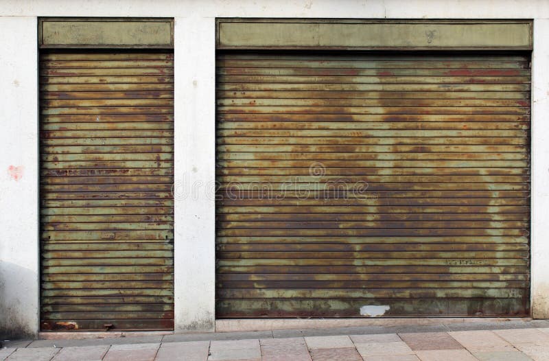 Closed Green Metal Rolling Shutters on an Old Building Stock Photo
