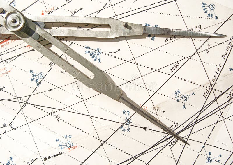 Old compass on a navigation chart