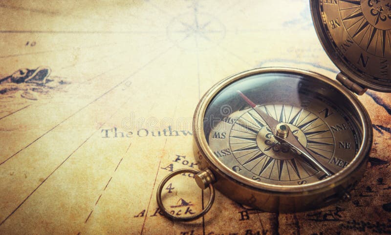 Old compass on vintage map. Adventure stories background.