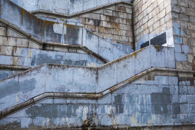 Old concrete building. Stairs leading to the bridge