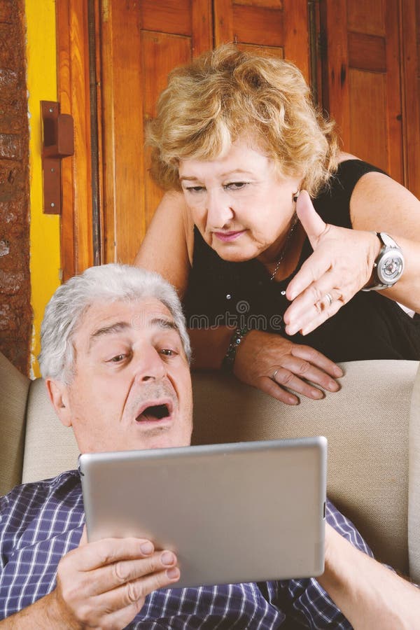Old couple using tablet. stock image