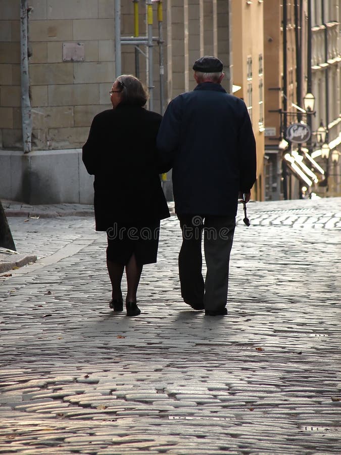 Old couple walking home