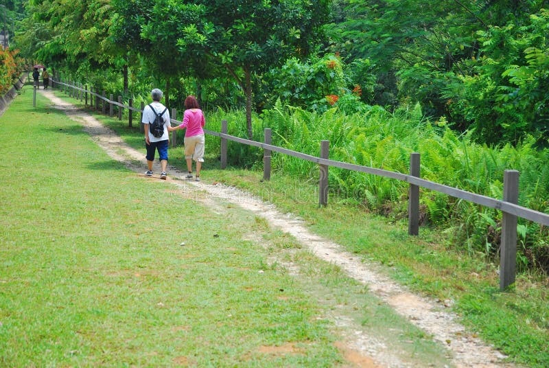 Old couple walking a long stretch of road