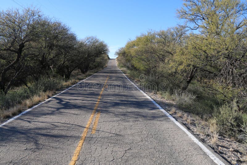 Old cracked two lane desert road horizon stock images Old cracked two lane desert road horizon stock images