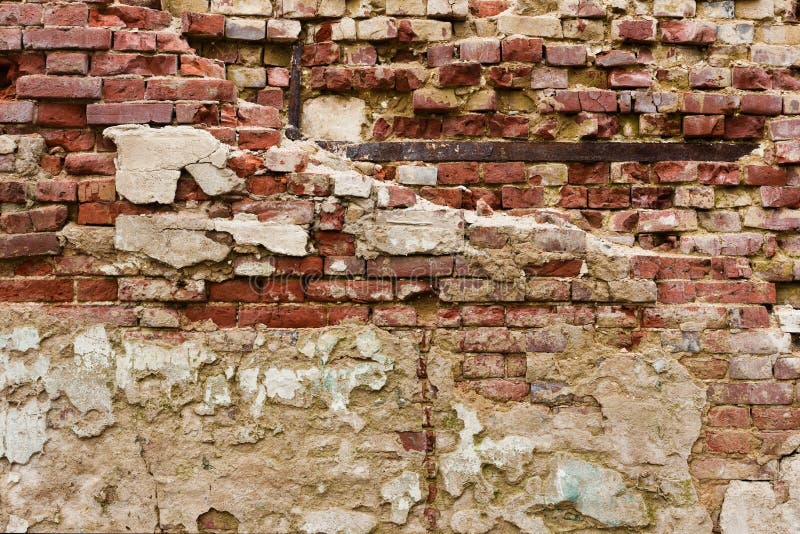 Old crumbling plastered brick wall