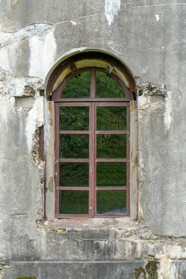 Old damaged plastered brick wall with window