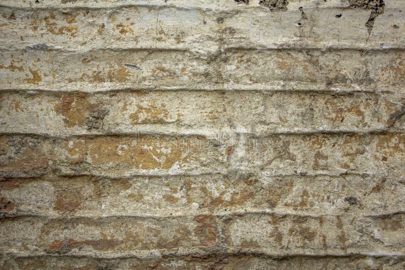 A Old Damaged White Gray Brick Wall with Cracks. Rough Surface Texture