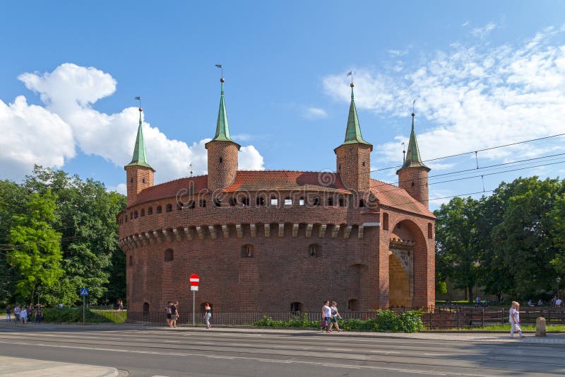Krakow, Poland - June 07 2019: The Krakow Barbican (Polish: Barbakan Krakowski) is a defense gateway from 1490s, once linked to the city walls. Krakow, Poland - June 07 2019: The Krakow Barbican (Polish: Barbakan Krakowski) is a defense gateway from 1490s, once linked to the city walls