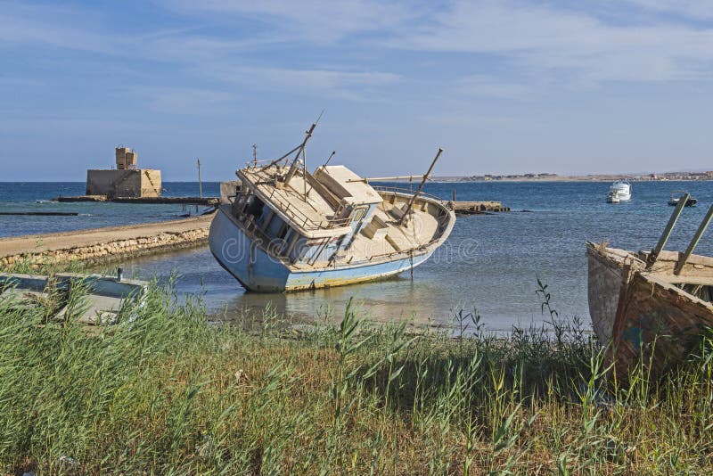Old derelict shipwrecked boat abandoned on beach