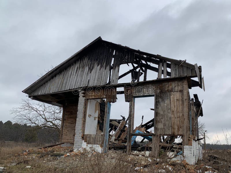Old Destroyed House after a Fire Against the Sky. Abandoned House with