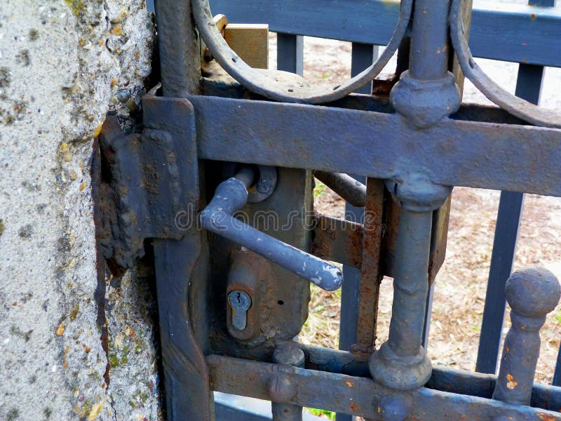 Deteriorating grunge wrought iron gate detail with lock stock photo Deteriorating grunge wrought iron gate detail with lock stock photo