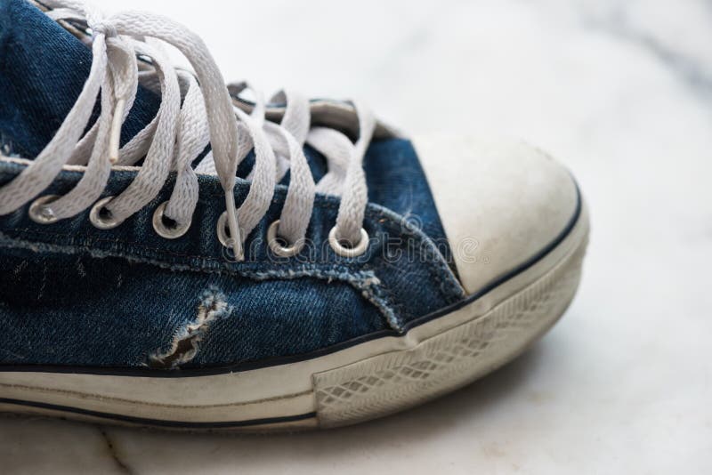 Old worn out blue sneaker stock photo 