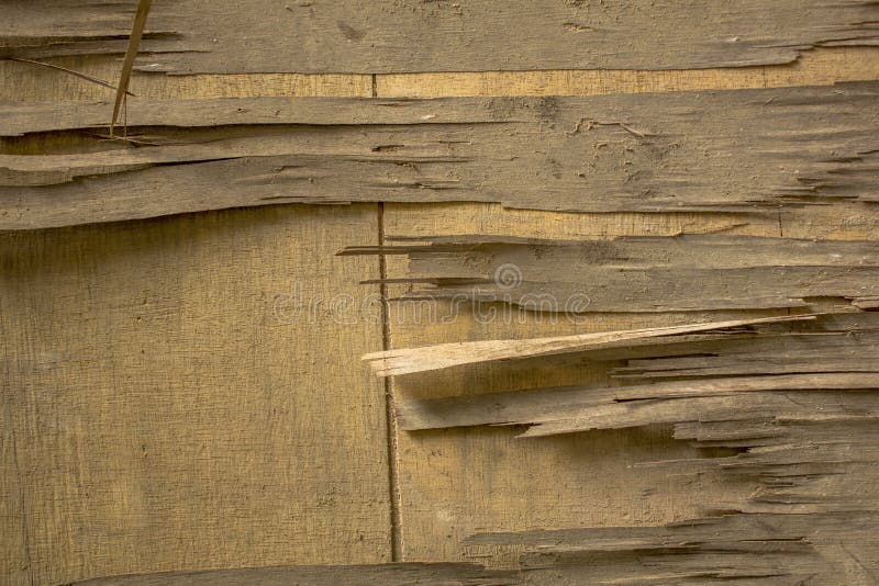 A old dirty broken light yellow plywood on a wooden surface. wooden texture royalty free stock image A old dirty broken light yellow plywood on a wooden surface. wooden texture royalty free stock image