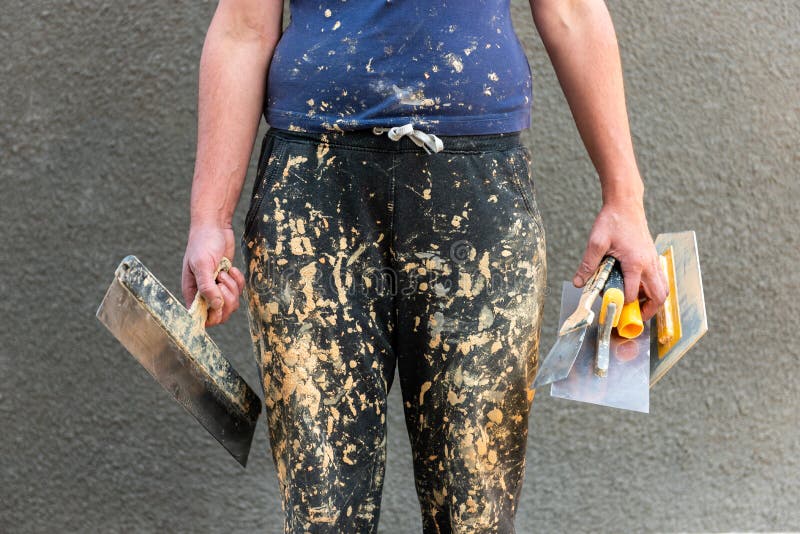 Old Dirty in Paint Work Pants on Worker with Construction Tools in