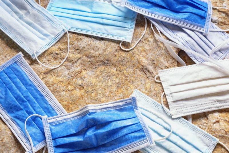 Old Discarded Medical Face Masks on Stones. Environmental Pollution