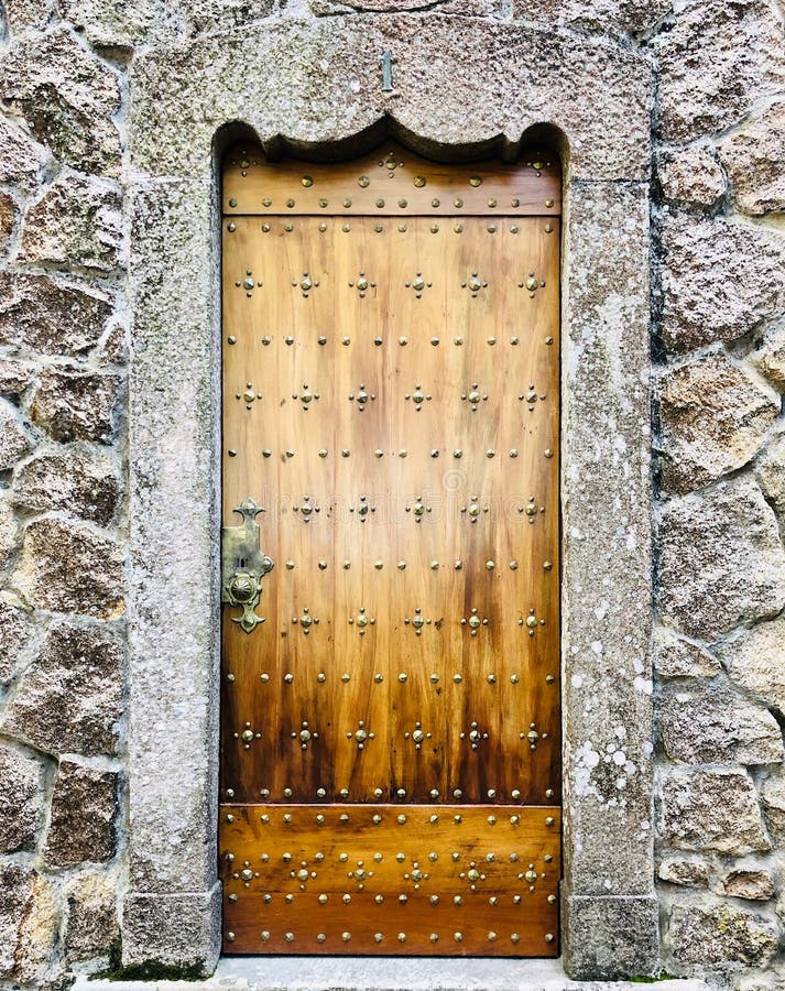 Old door of a castle in wooden wall with metal ornaments royalty free stock photography Old door of a castle in wooden wall with metal ornaments royalty free stock photography