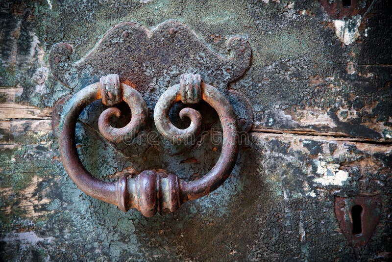 Old door-knocker with keyhole stock photography