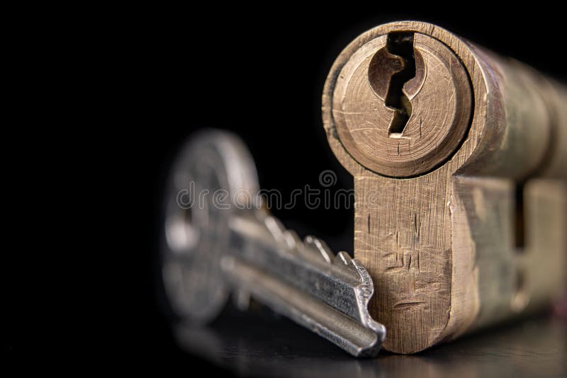 A old door lock on a dark background. A patent and keys to secure the front door stock photography