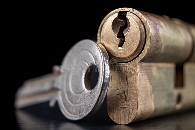 A old door lock on a dark background. A patent and keys to secure the front door royalty free stock photos