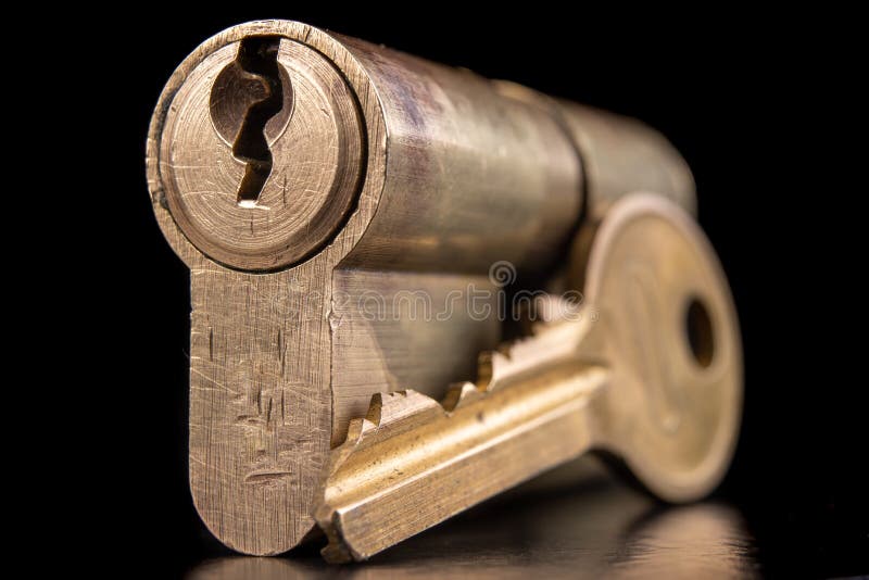 A old door lock on a dark background. A patent and keys to secure the front door royalty free stock image