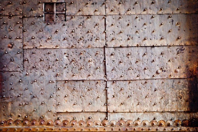 Old door rusty metal cover with rivets