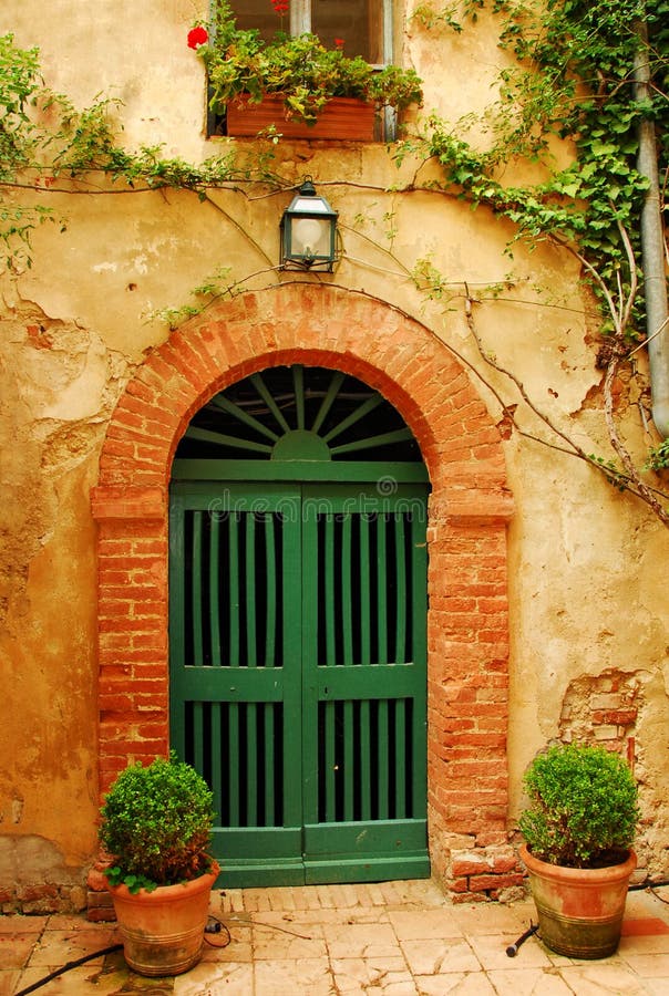 Old Door in Tuscany. A picturesque detail in the region of Tuscany in Italy Old Door in Tuscany. A picturesque detail in the region of Tuscany in Italy